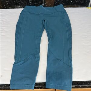 Size 10 Lululemon teal leggings with side pocket. Ankle length.